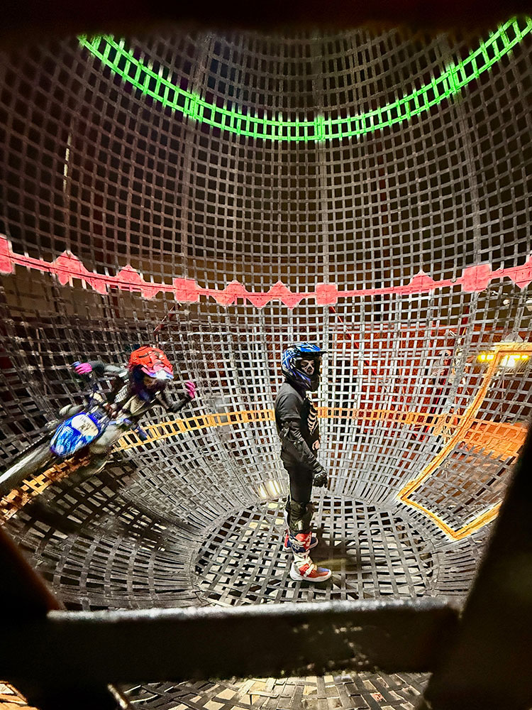 Scare actors performing circus bike trick.
